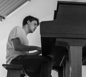 Remme playing piano black and white